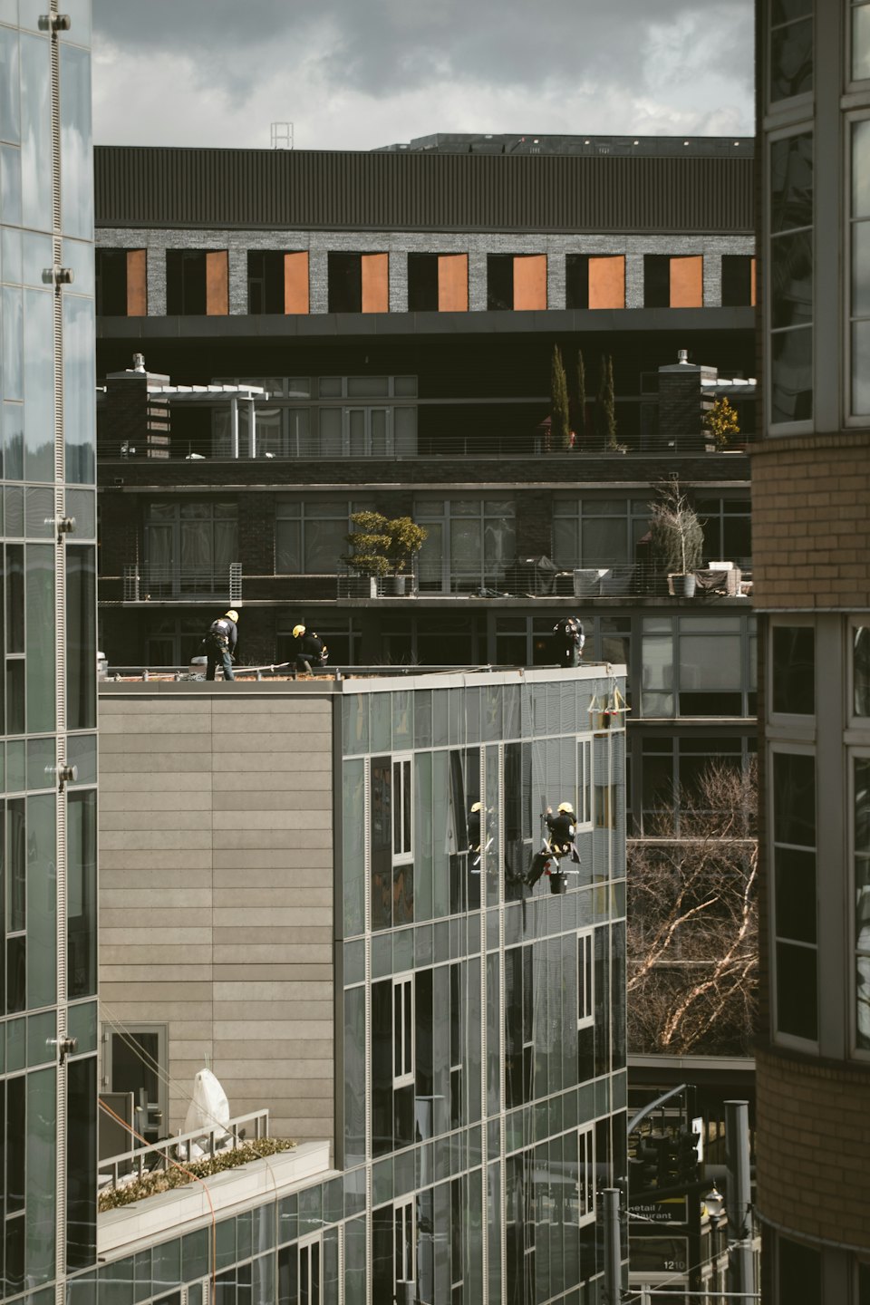 Werknemers die ramen lappen van een modern hoogbouw.